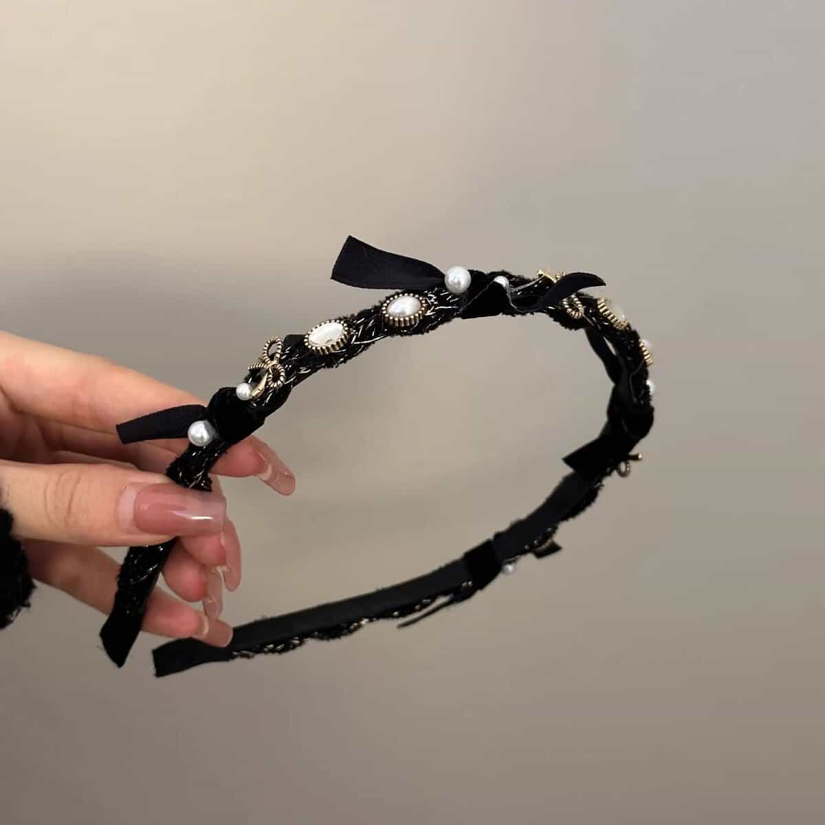 Black vintage pearl headband with gold accents and ribbon bow.